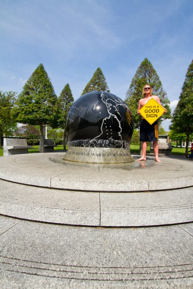 Person holding This Is A Good Sign at a landmark